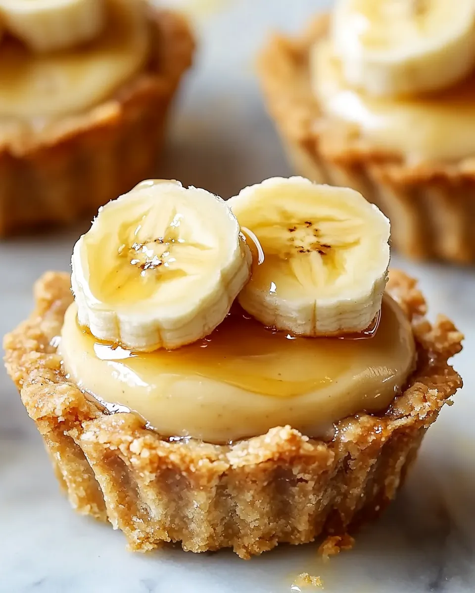 Two banana slices on top of a cream filling.