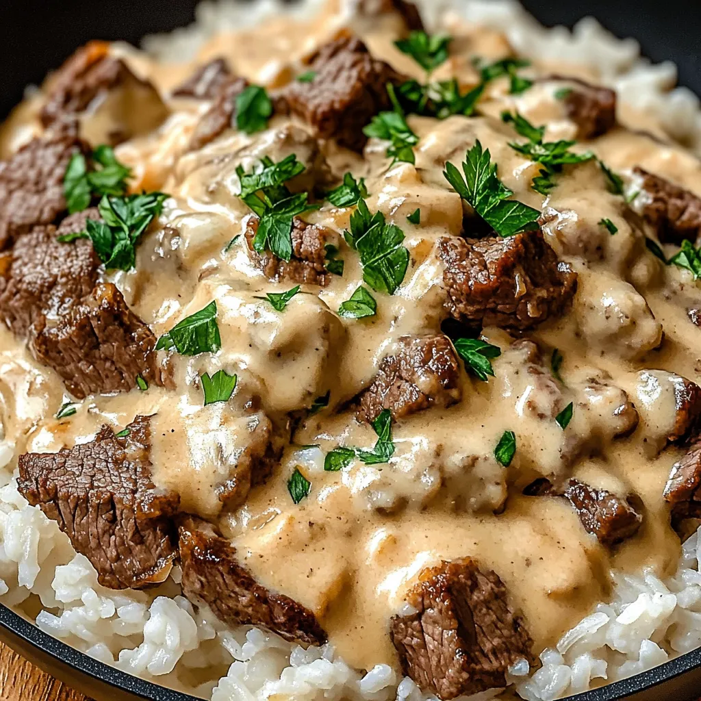 A bowl of rice with steak and cheese on top.