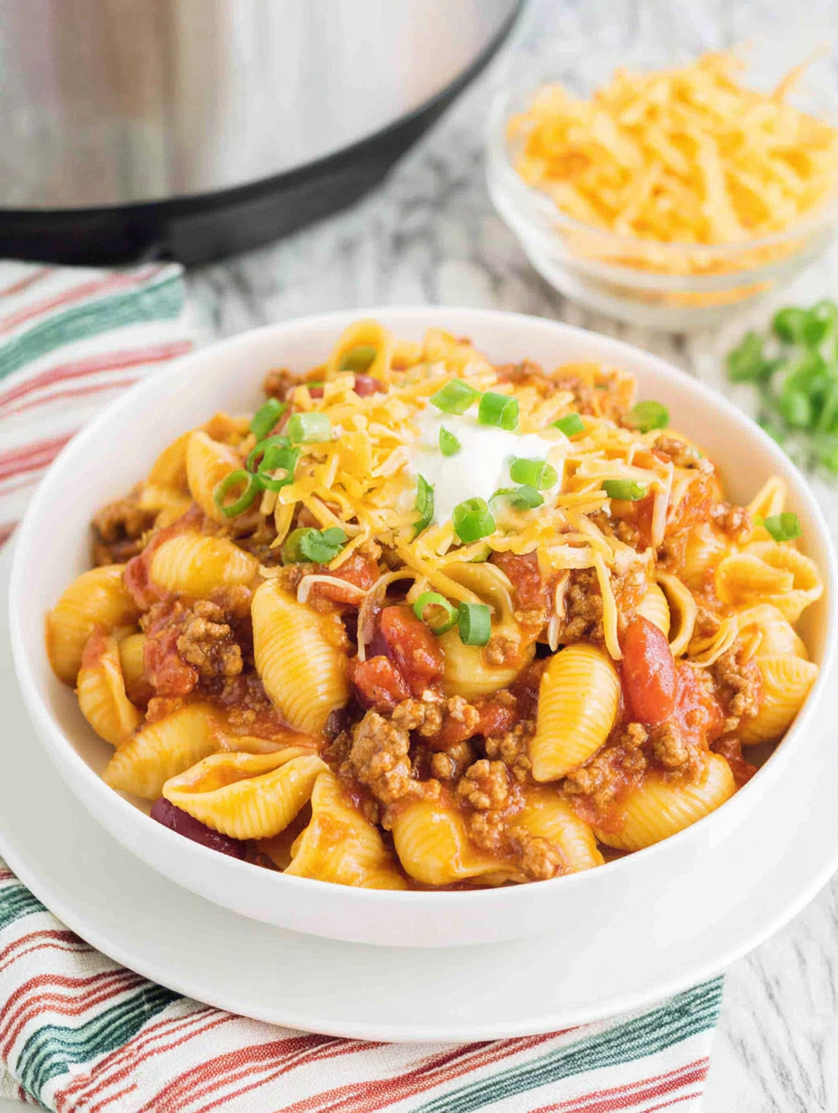 A bowl of pasta with meat and cheese.