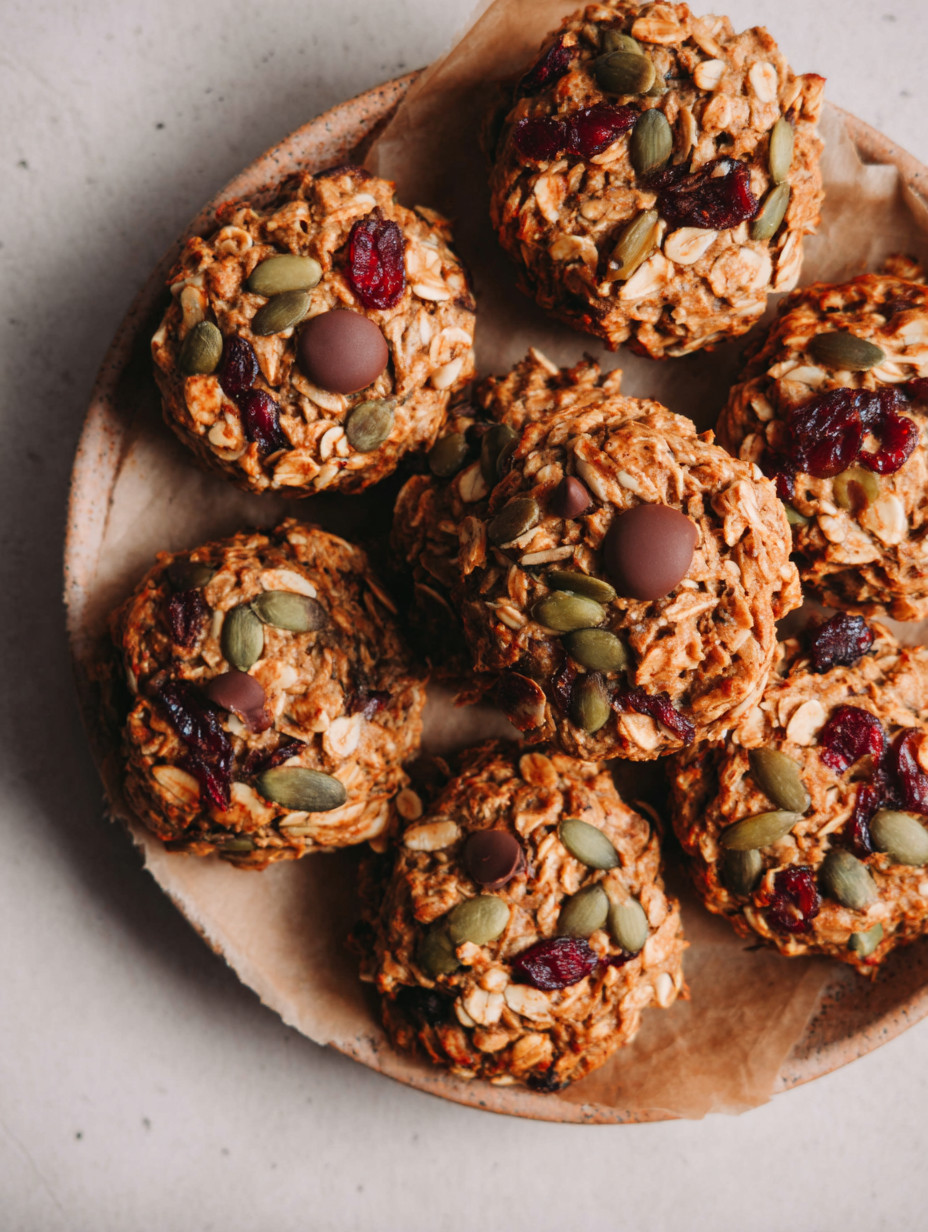 A plate of muffins with chocolate chips and nuts.