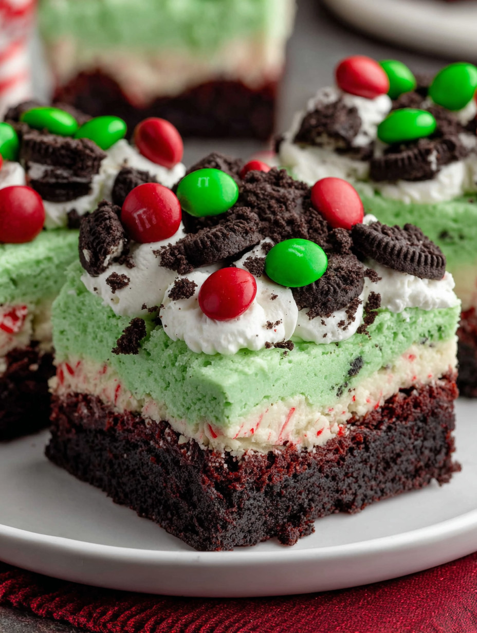 A close up of a chocolate cake with green and red decorations.