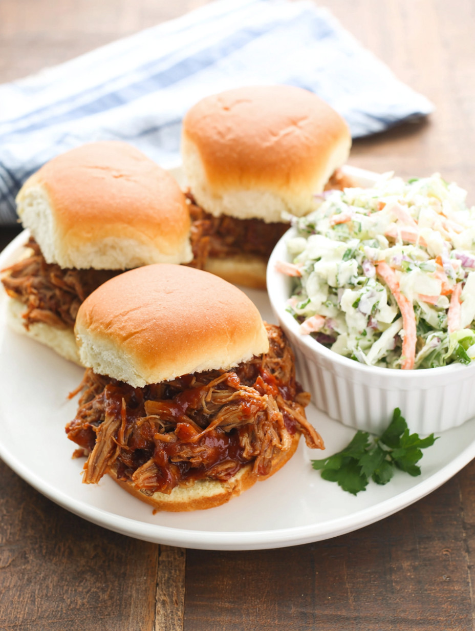A plate of barbecue sandwiches and coleslaw.