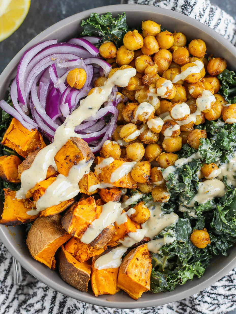 A bowl of vegetables with a white sauce.