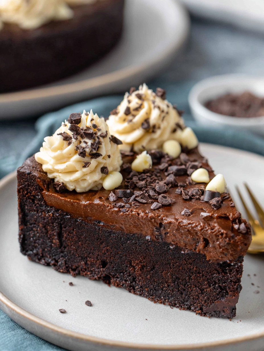A slice of chocolate cake with white frosting.