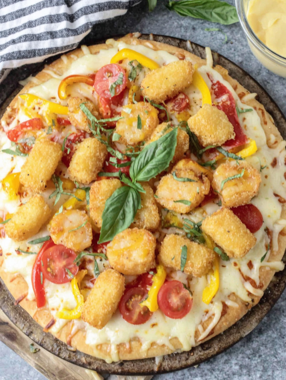 A pizza with tomatoes, peppers, and chicken.