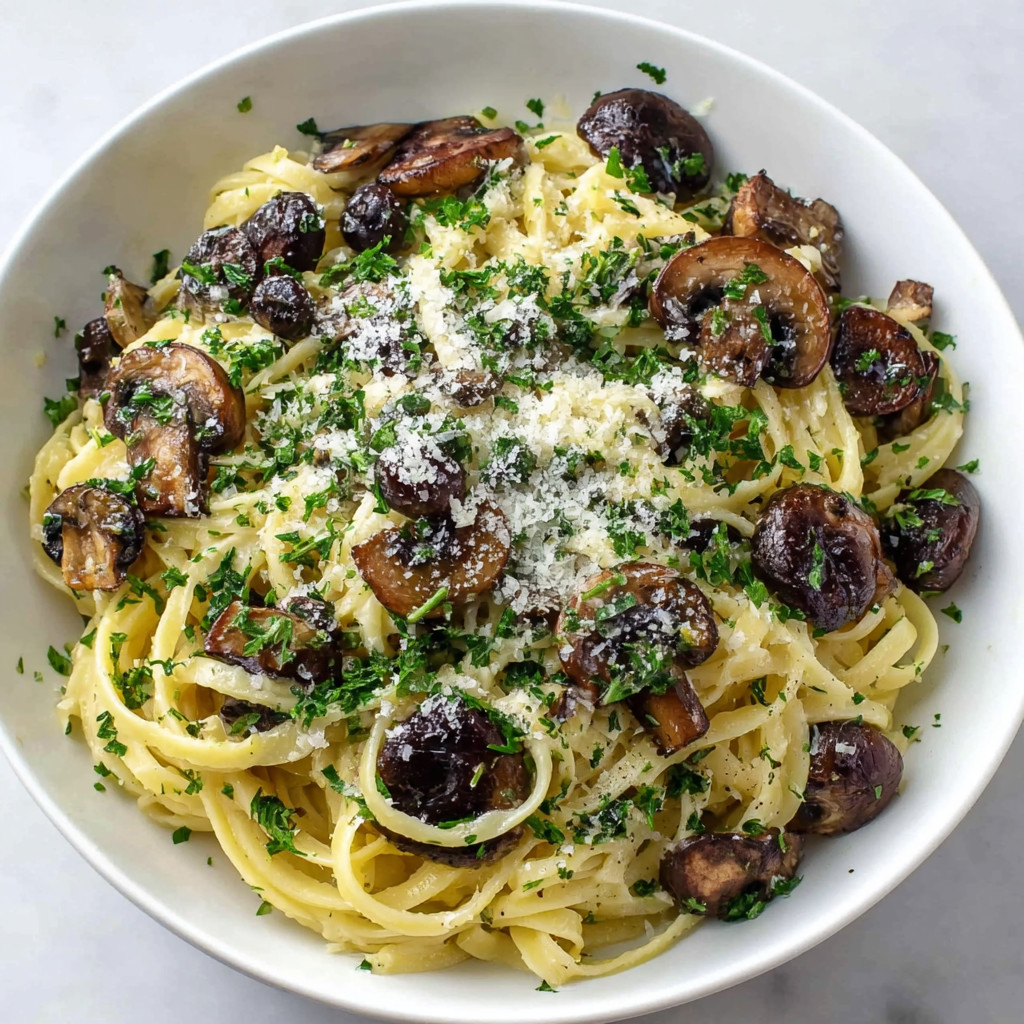 A bowl of pasta with mushrooms and cheese.