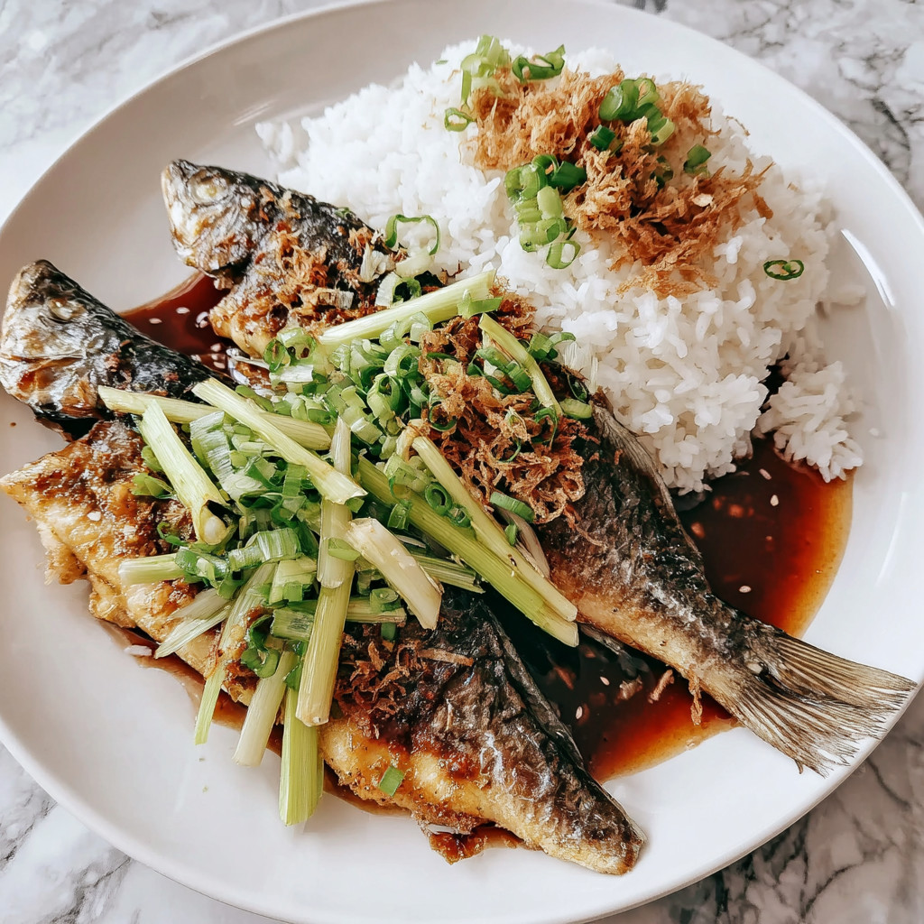 A plate of food with rice and fish.