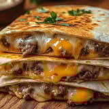 A stack of three quesadillas with cheese.