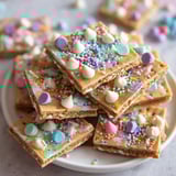 A plate of cookies with sprinkles on top.
