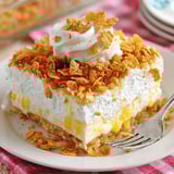 A piece of cake with a fork on a plate.