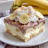 A dessert with bananas and whipped cream.