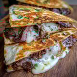 A stack of beef tacos on a wooden table.