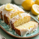 A slice of lemon cake with white icing.