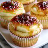 A cupcake with a caramel sauce on top.