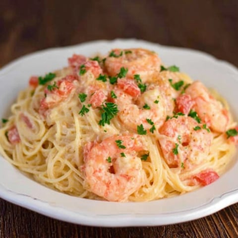 A plate of shrimp and pasta.