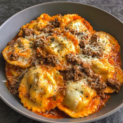 A bowl of pasta with meat and cheese.